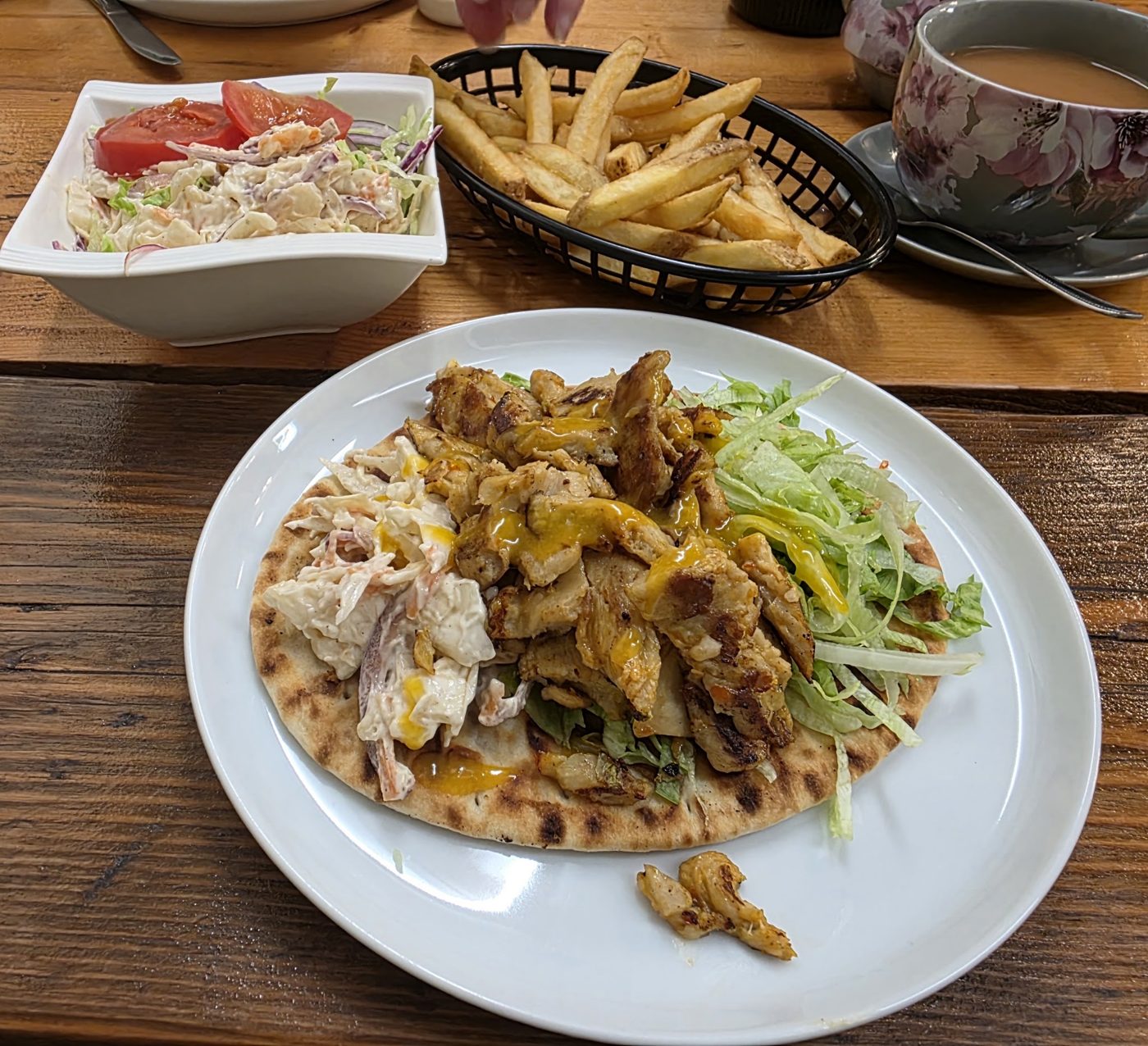 Chicken on flatbread with salad, fries and slaw